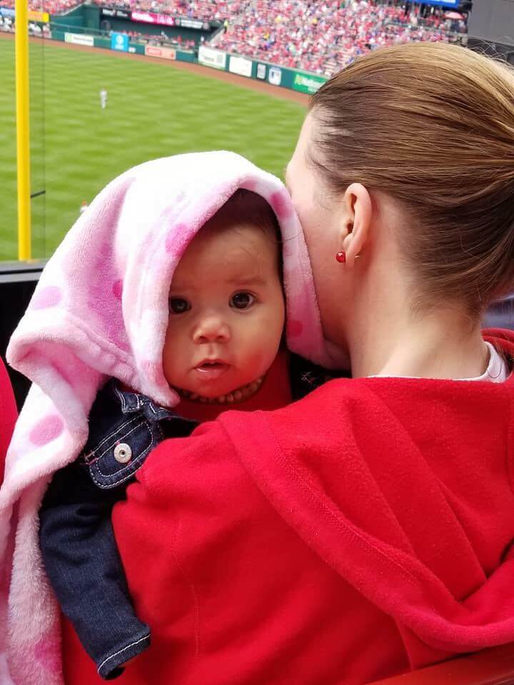 A baby being held by it's mother at the Infertility Awareness Day at the Ballpark 2018