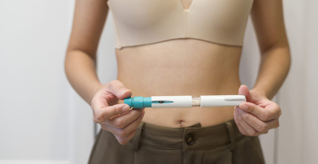 Fertility medication shot being displayed prior to administration.