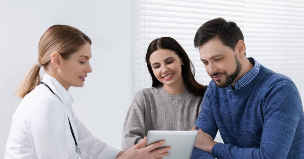 couple reviewing fertility results with doctor