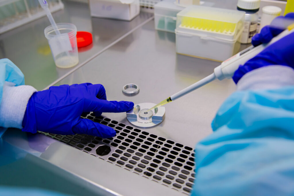 Semen sample being analyzed under a microscope in a fertility lab