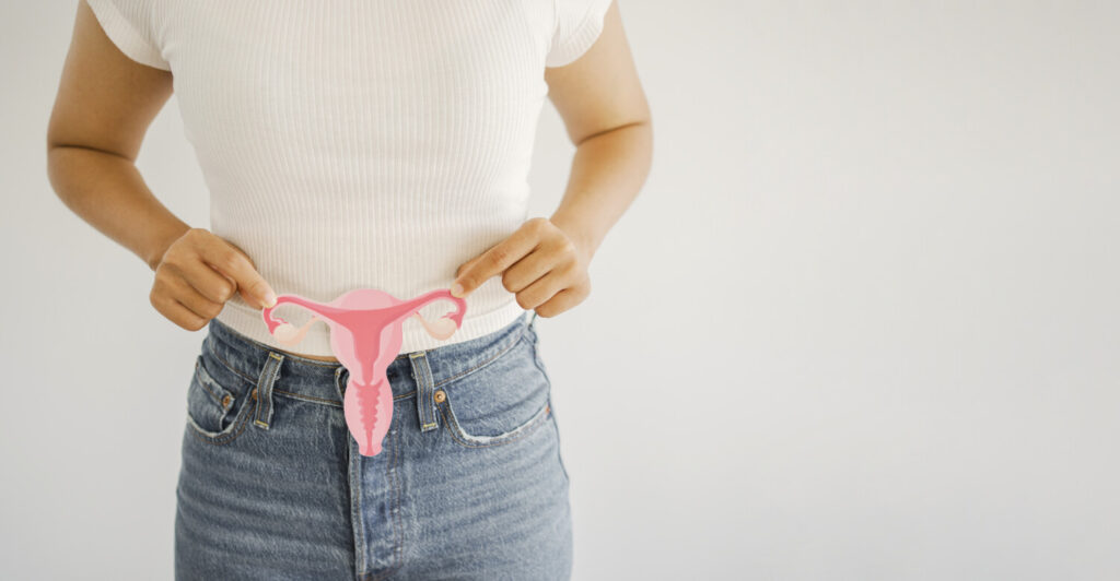 Woman holding a model of the uterus and ovaries