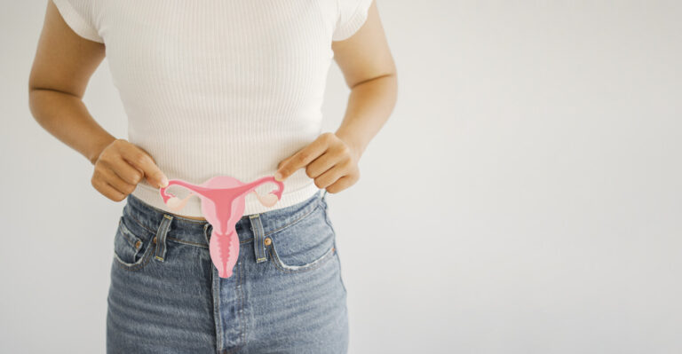 Woman holding a model of the uterus and ovaries