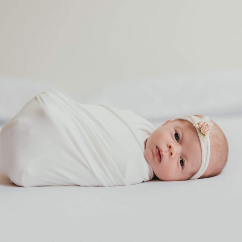 baby girl wrapped and looking